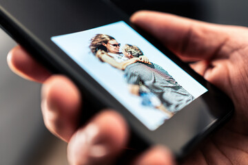 Picture of couple, ex girlfriend in phone. Sad man looking at photos of woman. Husband longing and...