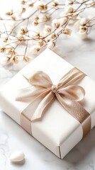 A beautifully wrapped white gift box adorned with a gold ribbon rests on a sleek marble surface, exuding luxury and elegance perfect for special occasions and high-end presentations