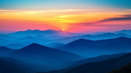 Obraz premium Silhouetted Mountains at Sunset with a Vibrant Sky