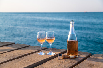 Wine in a glass on the seashore. Selective focus.