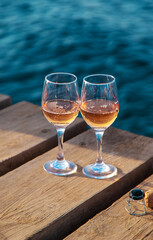 Wine in a glass on the seashore. Selective focus.