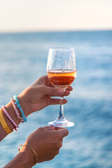 Wine in a glass on the seashore. Selective focus.