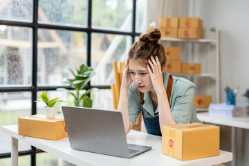 A woman is sitting at a desk with a laptop in front of her