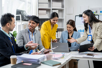 A group of people are sitting around a table in a business setting
