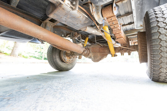 4x4 American off-road classic pickup truck  underneath picture axles shock absorbers yoke differentials muffler. High quality picture for download.