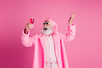 Photo of eccentric man excited hold champagne wear soft glamour robe hat isolated on pink color background