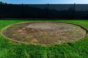 A burn mark on the lawn from the round outdoor swimming pool in the garden.