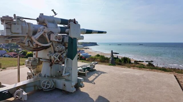 Smooth panning movement and close-up view about the World War II coastal military gun, Arromanches, France.