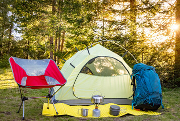 Camping with a tent and cooking equipment in the mountains.