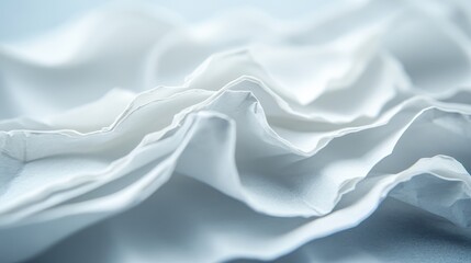 Fototapeta premium An artistic abstract shot showcasing crumpled white paper creating dynamic wavy textures and folds. The image captures minimalist beauty through light and shadow play.