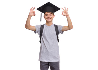 Teen boy in a gray T-shirt and graduation cap making OK gestures with both hands, smiling, isolated on white background.