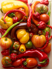 pile of tomatoes and different peppers isolated on white background