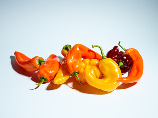 Pile of long sweet peppers over light blue background