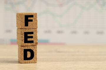 Cubes with letters Fed (Federal Reserve System) on wooden table, closeup. Space for text