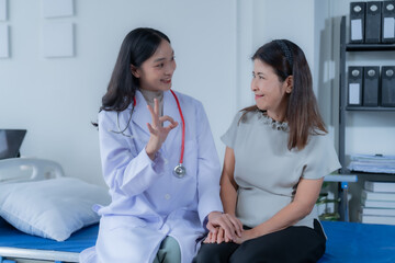 Fototapeta premium consulting female patient about pills and discussing health treatment sitting in the office at the desk. Medicine and health care concept. Doctor prescribing medicine to patient in the office.