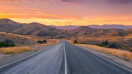 Route road at a late evening sunrise with the backdrop of sandy hills