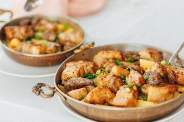 Grilled pork with onion and champignons, served with baked potatoes.