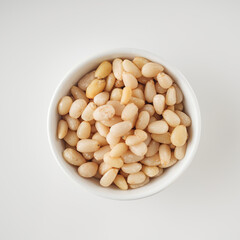 Shelled Pine Nuts: Close-Up of Roasted Siberian Seeds on a White Background