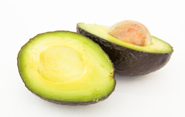 Halved avocado with bone on white background