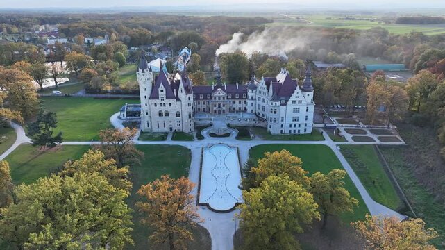 Moszna Castle.Aerial Drone Footage of Moszna Castle, Poland Stunning Views of the Majestic Neo-Gothic and Baroque Architecture Surrounded by Lush Gardens and Scenic Landscape in the Heart of Silesia.