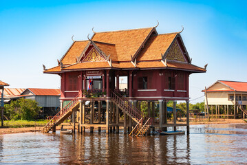 Administrative building in a floating village in Cambodia with traditional wooden houses