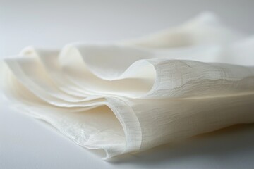Close-up shot of a folded napkin on a table, suitable for use in still life photography or as a prop in product or food photography