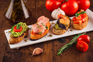 Delicious italian appetizer bruschetta presenting variety of toppings