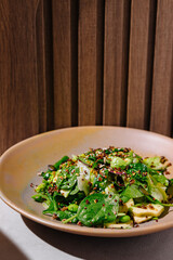 Healthy and colorful salad bowl is served on a table