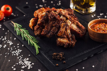 Delicious grilled pork ribs served on black stone cutting board