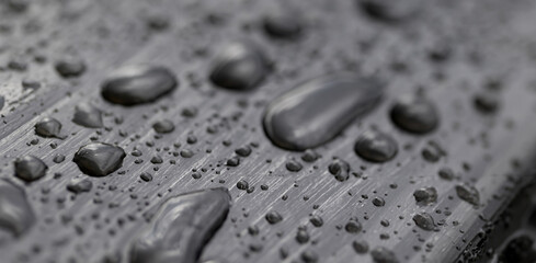 Close-Up of Water Drops on Black Water-Repellent Surface