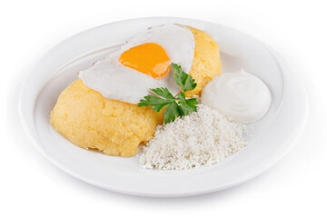 Delicious and healthy polenta with cheese, sour cream and fried egg on white plate