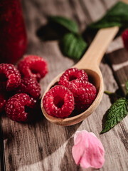 Fresh Raspberries: Juicy, Ripe Berries for a Healthy Summer Snack on a Wooden Background