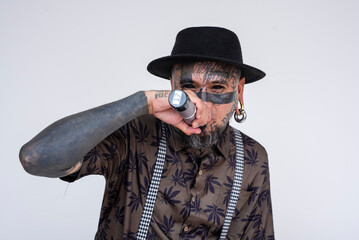 A controversial rapper freestyling lyrics on the microphone. A frontman full of face an body tattoos. Isolated on a white background.