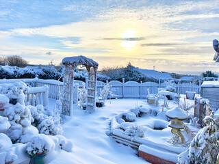 Heavy snow blankets an ornamental garden in the Isle of Man giving it a Christmas winter wonderland look