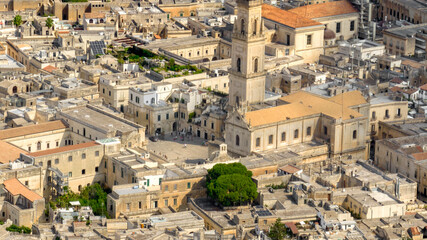 Naklejka premium Aerial view of the cathedral of Lecce, in Apulia, Italy. The metropolitan cathedral of Santa Maria Assunta with its tall bell tower is located in Piazza del Duomo, in the historic center of the city.