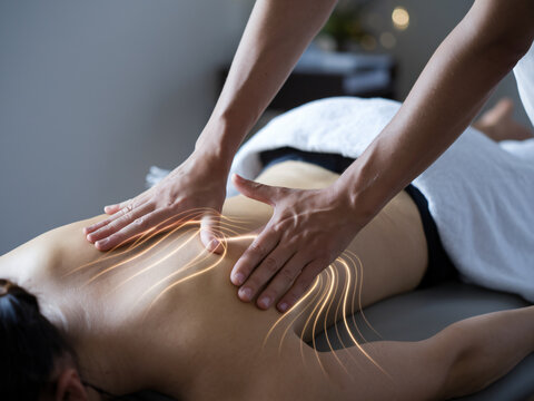 Therapists hands gently applying Tui Na massage techniques on clients back, promoting relaxation and healing. soothing atmosphere enhances therapeutic experience