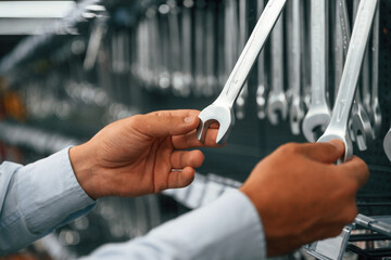 Bunch of wrenches. Man is in the hardware shop