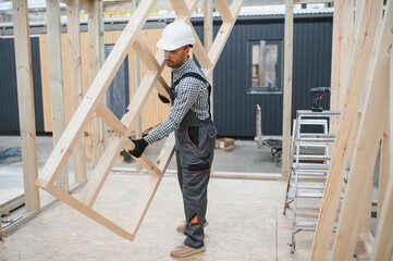 Process of construction new and modern modular house. Worker man in special protective uniform wear...