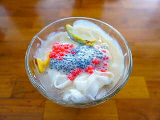 Refreshing Es Teler. Es Teler is an iced drink containing pieces of avocado, jackfruit, young coconut, chia seeds combined with syrup, coconut milk, sweetened condensed milk and ice cubes