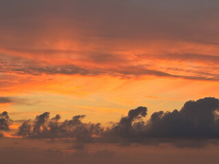 Spectacular firey red sunset sky with dark cloud formations