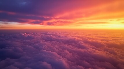 Aerial view of a cloudscape from an airplane during a colorful sunset, with the sky painted in shades of orange, pink, and purple
