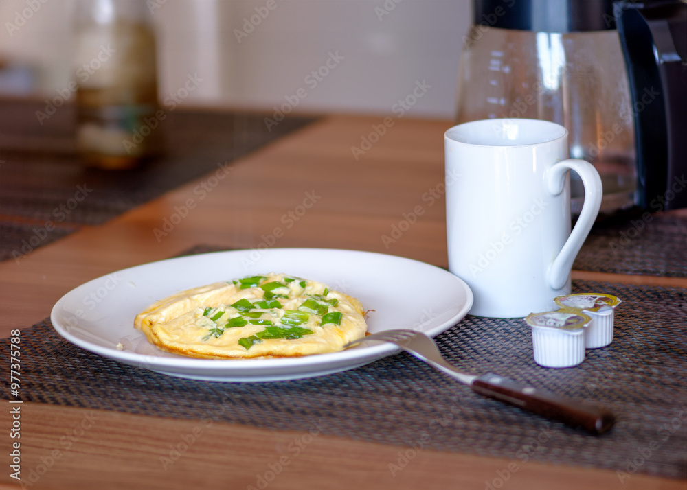 Wall mural omelette with green onions and coffee for breakfast