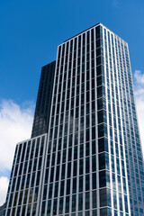 Obraz premium Modern skyscraper building. Architectural building in metropolis. Skyscraper perspective view. City architecture. Architecture of modern office building. Perspective city skyscraper. Modern city