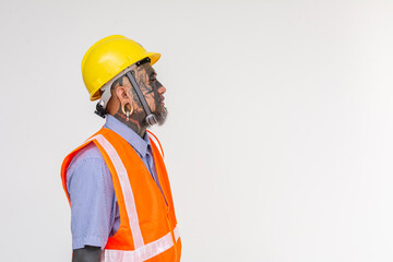 Side view of an unconventional looking engineer in a hard hat and vest. Full of face tattoos and piercings. Isolated on a white background.