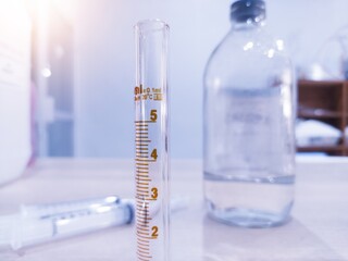 Close up the Borosilicate glass measuring  to measure doses for laboratory purposes.