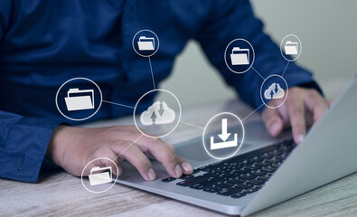 Man using laptop to download media or update software. Downloading process bar on virtual screen.