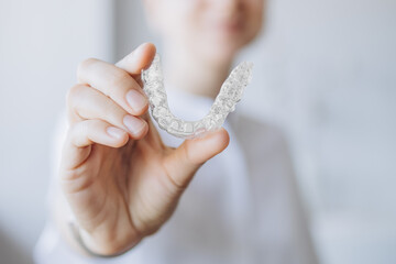 Doctor Showing A Transparent Aligner Tray, Holding Invisalign-Like For Orthodontic Treatment. New Technology For Teeth Straightening. Dental Health Medical Care Concept.