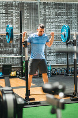 Athlete lifting weights during back squat exercise at the gym