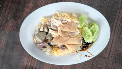 Chicken rice in a white plate on the dining table