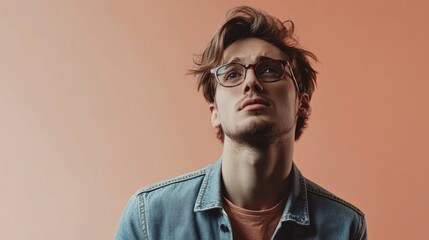 Fototapeta premium Contemplative Young Man with Glasses, Looking Away